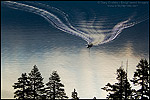 Photo: Boat wake on still quiet water below trees, Emerald Bay State Park, South Lake Tahoe area, California