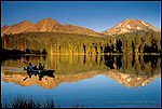 Picture: Sunset light on mountain over Family paddle kayak on blue water at Manzanita Lake, Lassen Volcanic National Park, California