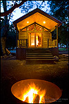 Photo: Evening campfire in fire pit in front of rustic wood cabin, El Capitan Canyon Resort, near Santa Barbara, California