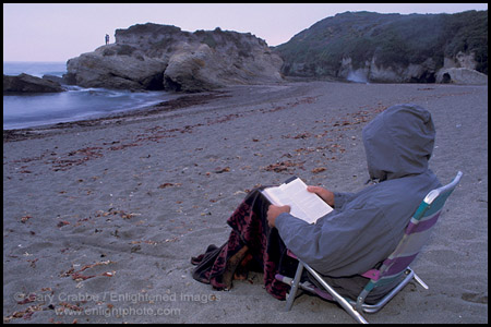 Person reading on the coast on a cool evening, Montana del Oro State Park, San Luis Obispo County, California