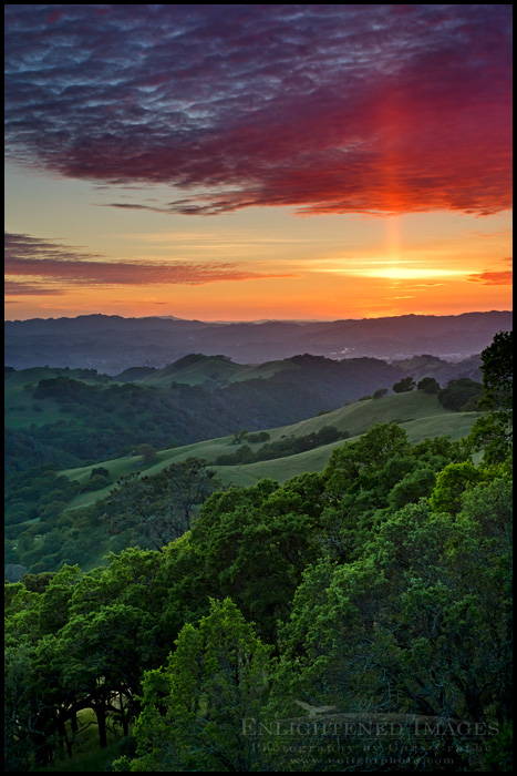 Picture: Sun Pillar at sunset over green hills in Spring, Mount Diablo State Park, California