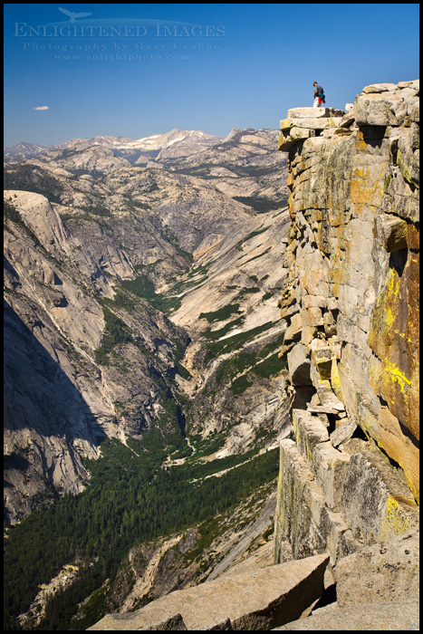 Image: Hiker checking out the view from the summit of Half Dome, Yosemite National Park, California