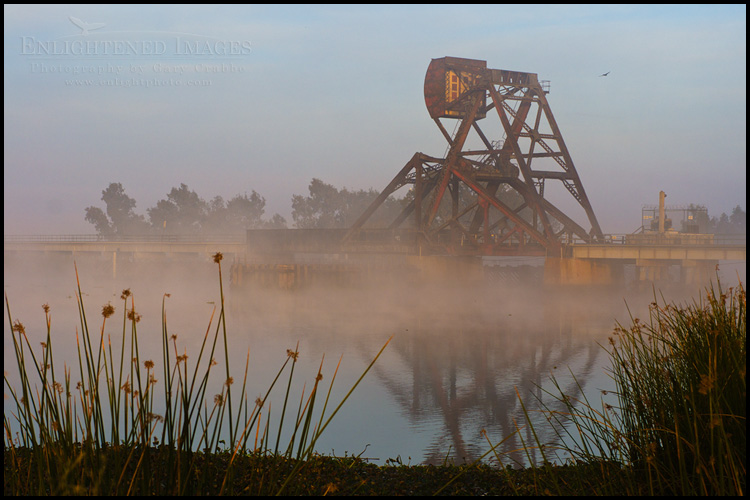 Image: A railroad trestle and counter-weighted draw bridge in the the Sacramento - San Joaquin River Delta at sunrise, California