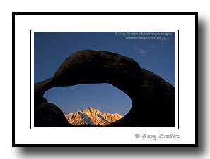 Arch rock over mountain peak in Eastern Sierra, Alabama Hills, Lone Pine, California