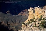 Picture: Dumb tourist standing out on a narrow rock ledge on the rim of the Grand Canyon, Grand Canyon National Park, Arizona