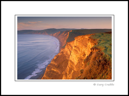 Morning light on steep coastal cliffs at Drakes Bay, Point Reyes National Seashore, Marin County Coast, California