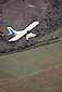 Small single engine fixed wing plane (Maule) over vineyards in the Napa Valley, California