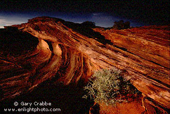 Sunset light on desert sandstone formation during a fall storm, near Page, Arizona