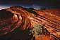 Sunset light on desert sandstone formation during a fall storm, near Page, Arizona