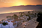 Sunset over the Pacific Coast Highway sand beach and mountains, Santa Monica, California Sunset over PCH Pacific Coast Highway road and mountains along sand beach at Santa Monica, Los Angeles, California