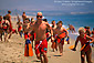 Kids running on sand beach in Junior Lifeguard Summer education camp, Balboa Island, Newport Beach, Orange County Coast, Southern California