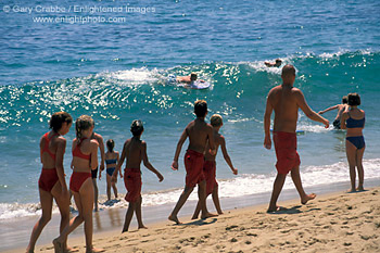 Kids walking on sand beach in summer class Junior Lifeguard Camp, Balboa Island, Newport Beach, California