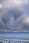 Storm clouds building over the Panamint Mountains and water filled desert basin in spring, near Badwater, Death Valley National Park, California