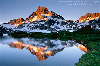 Alpenglow light at sunrise reflects off Banner Peak into 1000 Island Lake, Ansel Adames Wilderness, Eastern Sierra, California