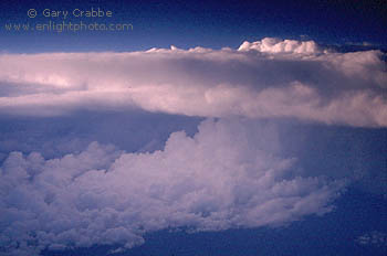 Sunset light on top of cumulonimbus thunderstorm cloud as seen from 35,000 feet