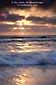 Sunset light through fog clouds over breaking wave, Torrey Pines State Park, San Diego County, California