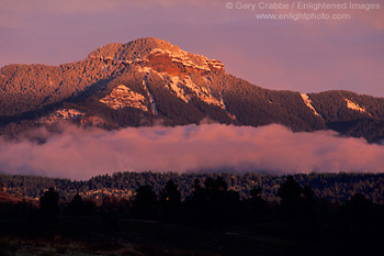 Sunset light on fog bank below Square Top Mountain after a fall snow storm, San Juan Mountains, near Pagosa Springs, Colorado