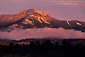 Sunset light on fog bank below Square Top Mountain after a fall snow storm, San Juan Mountains, near Pagosa Springs, Colorado
