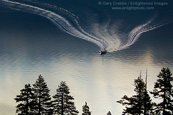 Sailboat and boat wake in calm water, Emerald Bay, Lake Tahoe, California