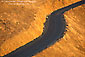 Picture: Two lane twisting asphalt road and golden grass hillside at sunset, Mount Tamalpais, Marin County, California