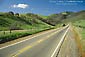 Image: Clouds and sunbeams in blue sky over dirt road, Escalante Region, UtahImage: Two lane rural country road through green hills in spring, near Mount Diablo, California