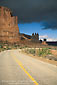 Image: Storm clouds over road bend and red sandstone cliffs, Arches National Park, Utah
