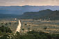 Photo: Long straight empty dirt road through high desert, Grand Staircase Escalante National Monument, Utah