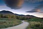 Image: Dirt road curves through field at sunrise, White Mountains, New Hampshire