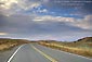 Picture: curving two lane rural country highway road below blue sky and clouds, Glenn County, California