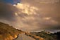 Image: Storm clouds at sunset over empty two lane mountain road, Mount Diablo State Park, California