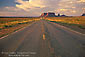 Picture: Long straight endless two lane road through the desert, Monument Valley, Arizona