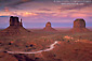 Image: Dirt road through desert under red sky sunset, Monument Valley, Arizona