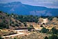 Picture: Twisting rural dirt road through hills near Ghost Ranch, New Mexico