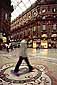 Tourist stepping on the Bull, Piazza di Duomo, Milan, Italy