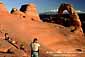 Tourists gather at sunset in the Delicate Arch ampitheater, Arches National Park, Utah