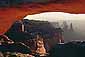 Sunrise light on Mesa Arch and red cliffs of Canyonlands National Park, Utah