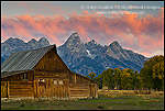 Sunrise light on the Grand teton mountain peak over old wooden barn, Mormon Row, Grand Teton National Park, Wyoming